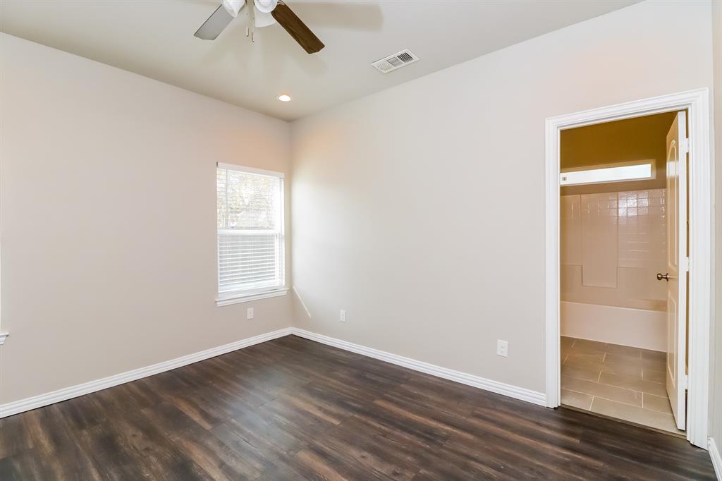 206 Perry Avenue Waxahachie, TX 75165 - Photo 8 of 15 an empty room with a empty space and windows