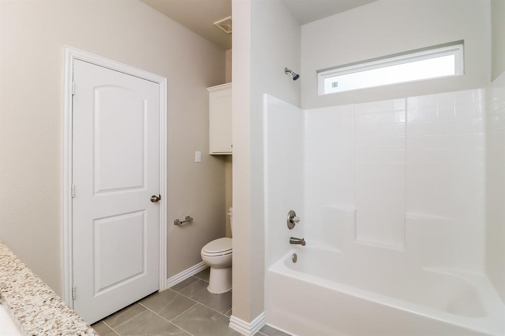 206 Perry Avenue Waxahachie, TX 75165 - Photo 10 of 15 a bathroom with a bathtub and a shower