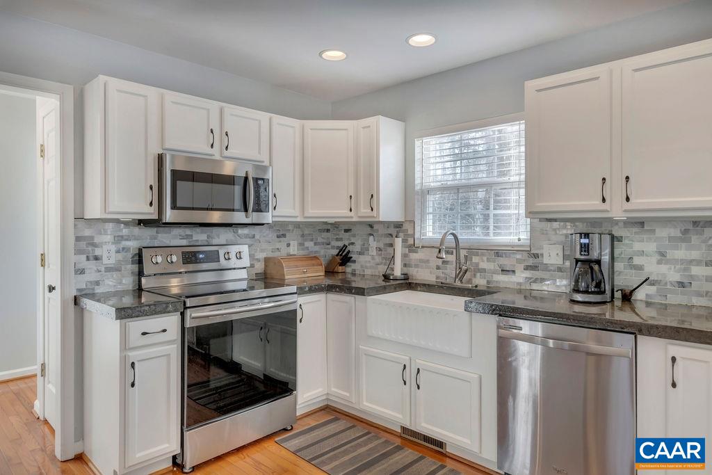 27 Zephyr Road Palmyra, VA 22963 - Photo 13 of 34 a kitchen with granite countertop a sink stove top oven and microwave