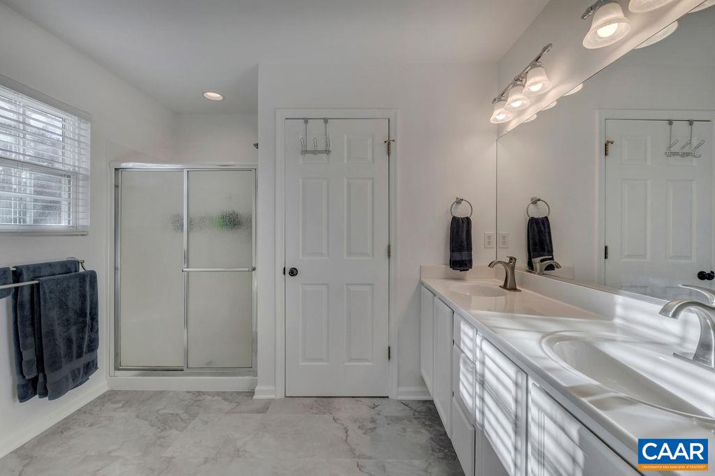 27 Zephyr Road Palmyra, VA 22963 - Photo 23 of 34 a bathroom with double vanity and a mirror