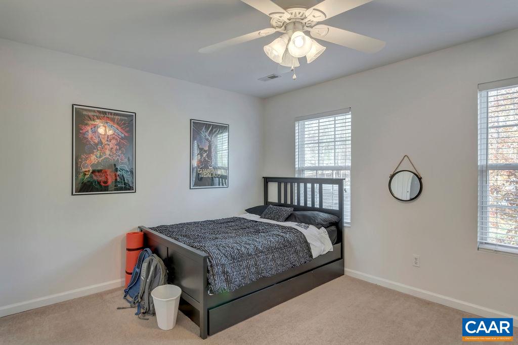 27 Zephyr Road Palmyra, VA 22963 - Photo 25 of 34 a bedroom with a bed and a chandelier
