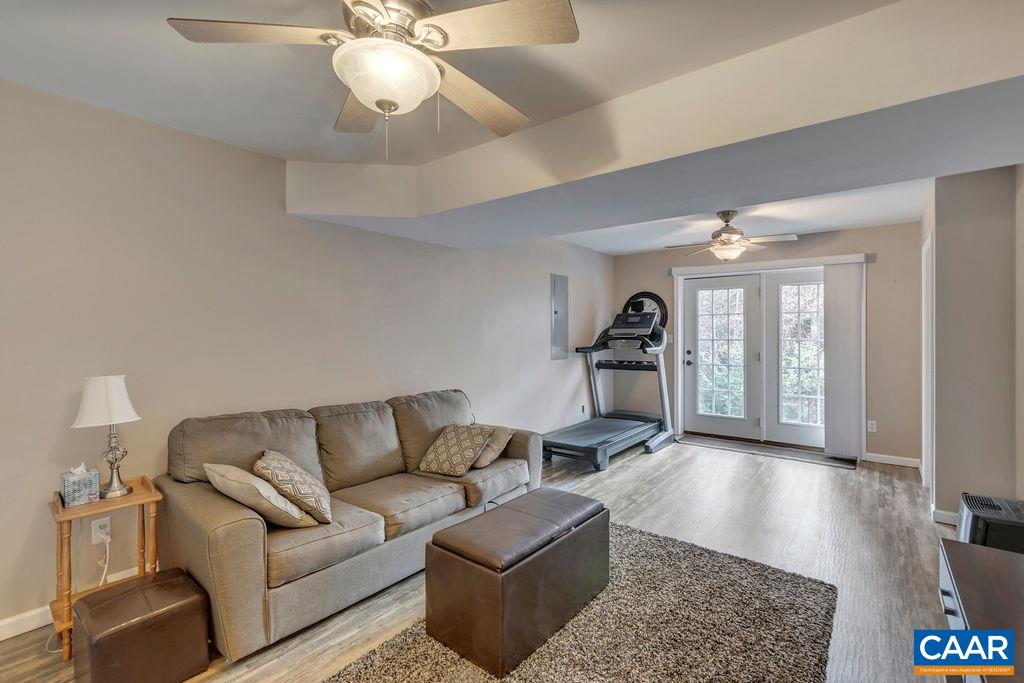 27 Zephyr Road Palmyra, VA 22963 - Photo 29 of 34 a living room with furniture and a chandelier