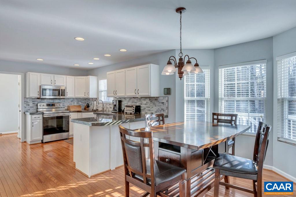 27 Zephyr Road Palmyra, VA 22963 - Photo 10 of 34 a kitchen with refrigerator cabinets dining table and chairs