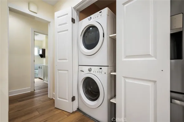 a view of a hallway with stairs and a refrigerator