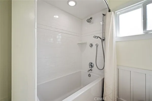 a view of a hallway with wooden floor and closet area