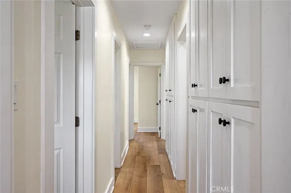 a view of a hallway with wooden floor