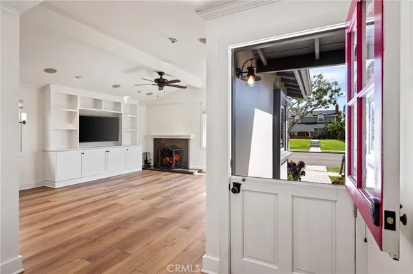 a view of empty room with wooden floor and fireplace