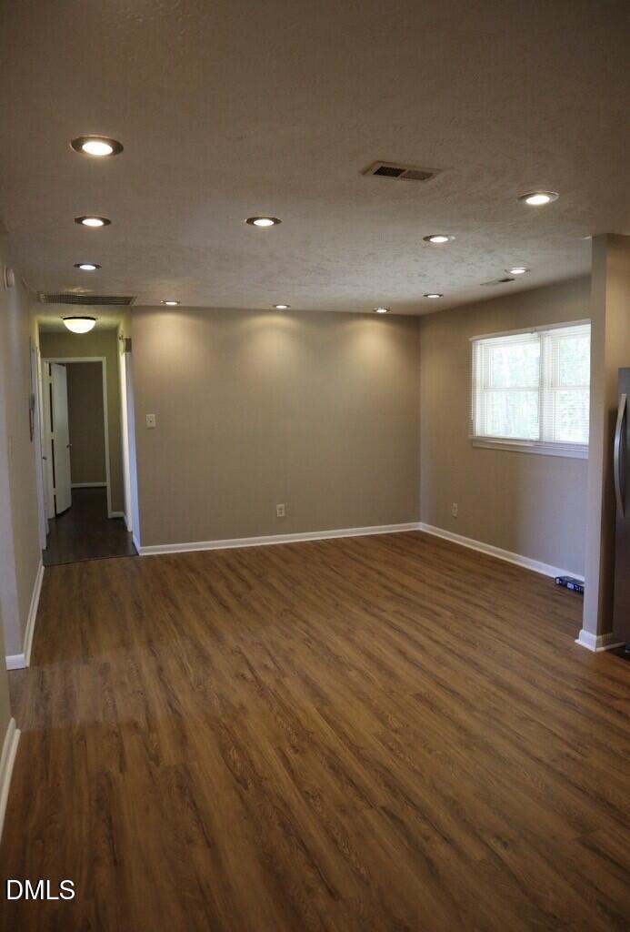 6591 Goldsboro Road Wade, NC 28395 - Photo 13 of 33 an empty room with wooden floor and windows