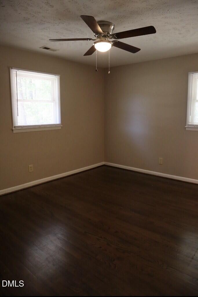 6591 Goldsboro Road Wade, NC 28395 - Photo 14 of 33 a view of an empty room with wooden floor and a window