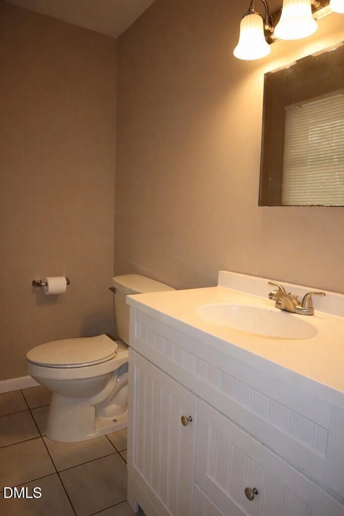 6591 Goldsboro Road Wade, NC 28395 - Photo 16 of 33 a bathroom with a toilet a sink and mirror