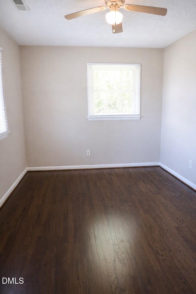 6591 Goldsboro Road Wade, NC 28395 - Photo 17 of 33 an empty room with wooden floor and windows