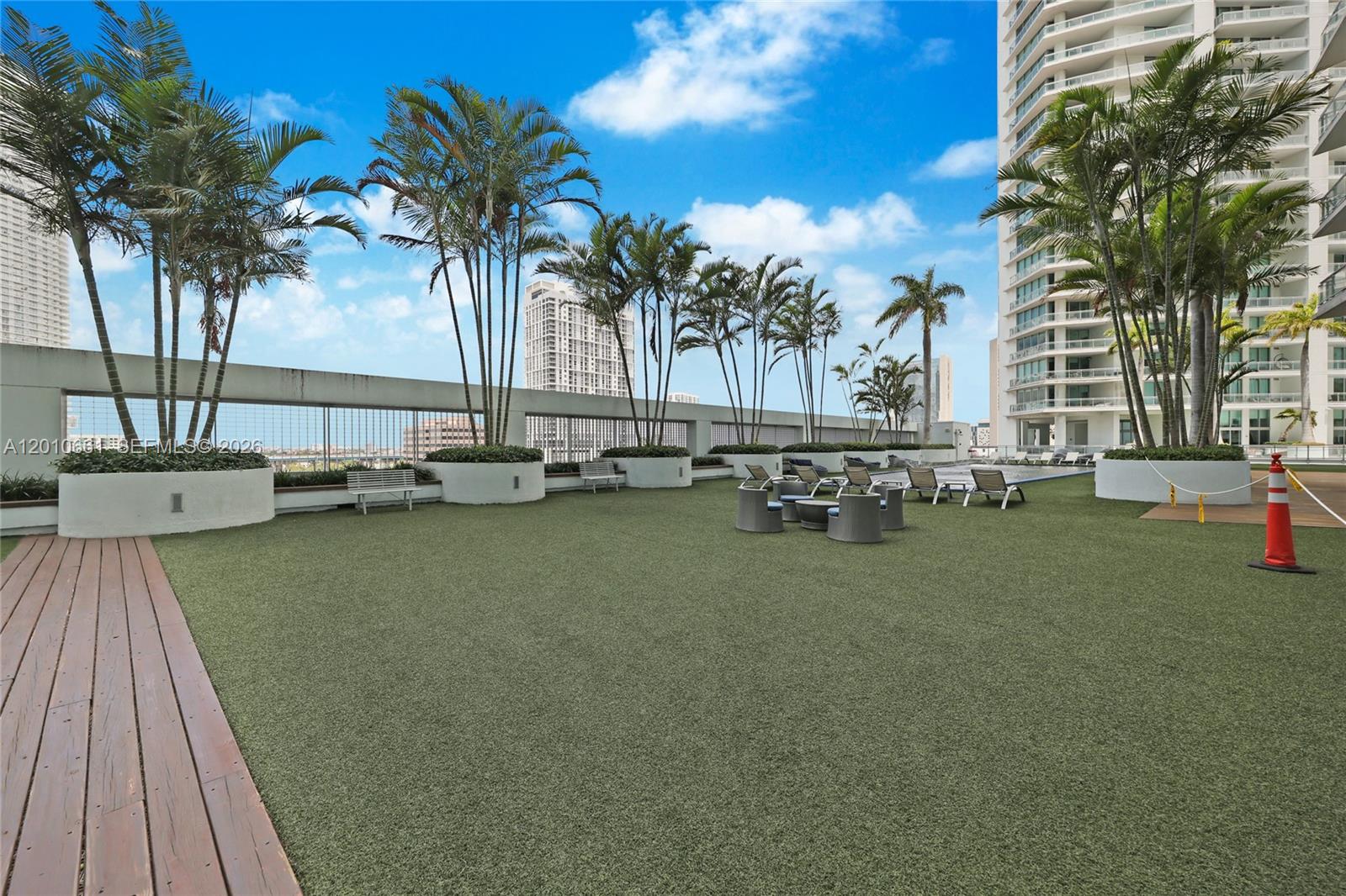 92 Southwest 3rd Street, Unit 5202 Miami, FL 33130 - Photo 23 of 27 a row of palm trees and swimming pool in the backyard of a house