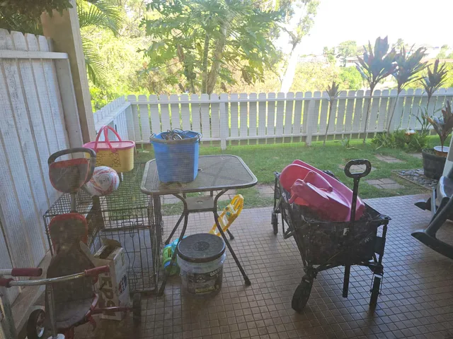a view of a table and chairs in back yard of the house
