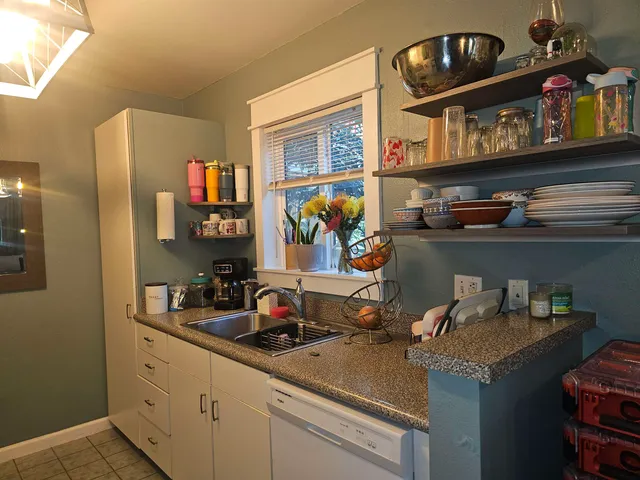 a kitchen with a sink and cabinets