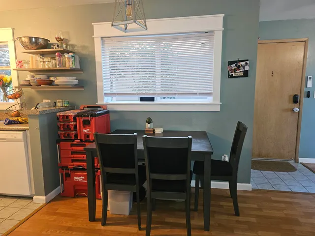 a view of a dining room with furniture and window