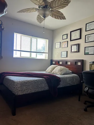 a bed sitting in a bedroom next to a window