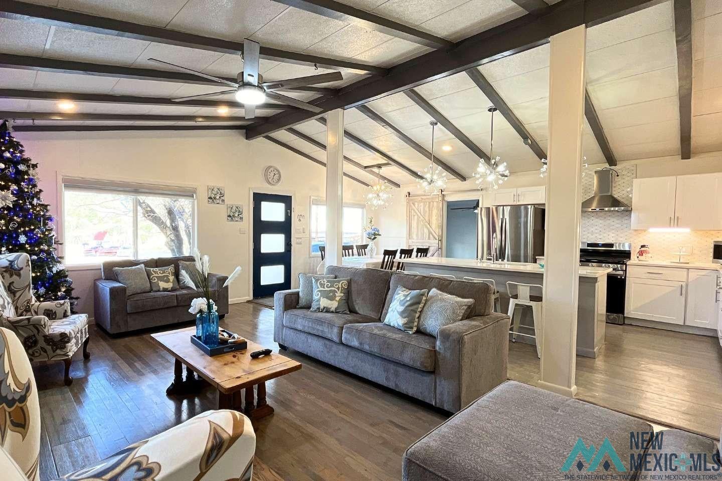 241 Junction Road Ruidoso, NM 88345 - Photo 2 of 44 Living room with dark wood-style flooring, a chandelier, and ceiling fan
