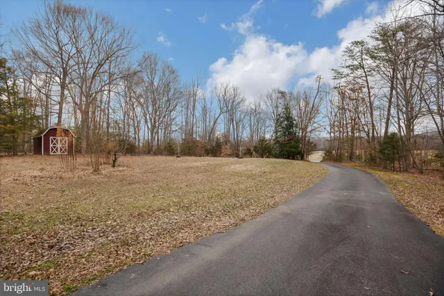 a view of a yard with snow on the road