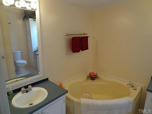 175 MacBeth Lane Roxboro, NC 27574 - Photo 12 of 24 The MASTER BATHROOM offers a garden tub, separate shower, and two sink vanities.