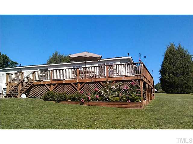 175 MacBeth Lane Roxboro, NC 27574 - Photo 15 of 24 The exterior rear of 175 Macbeth Lane and its spacious WRAP AROUND DECK.