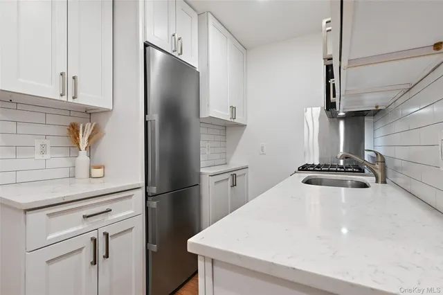 a kitchen with stainless steel appliances a refrigerator and a stove