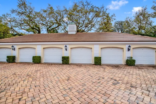 a front view of a house with a yard and a garage