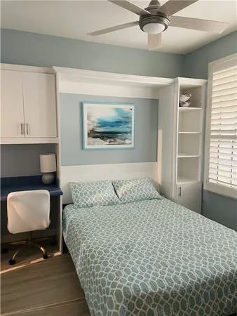 a bedroom with a bed dresser and a window
