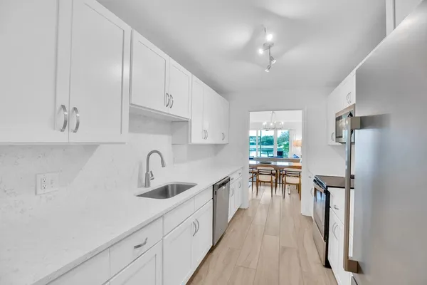 a kitchen with kitchen island granite countertop lots of counter top space and appliances