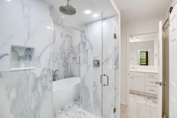 a bathroom with a bathtub a toilet a sink and shower