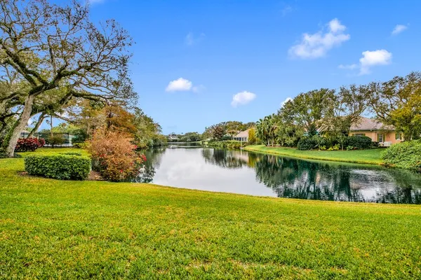 a view of a lake with a house in the background
