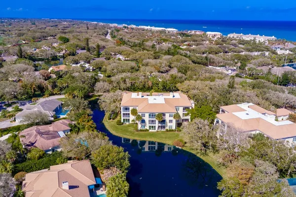 an aerial view of a houses with a swimming pool