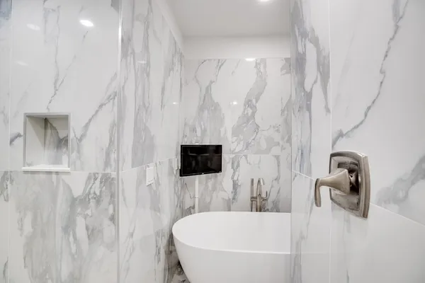 a bathroom with a tub and a shower
