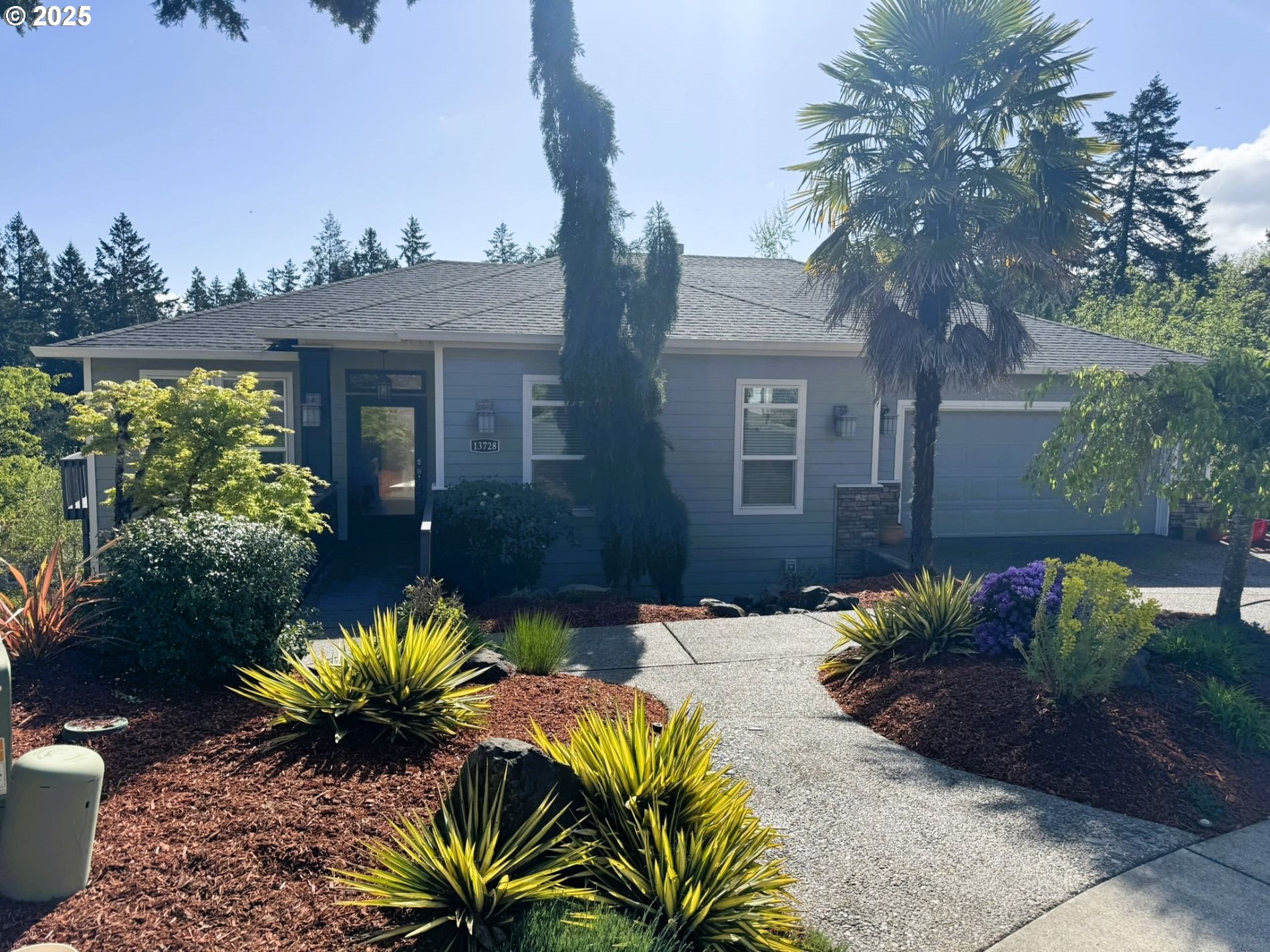 a view of a house with a yard and garden