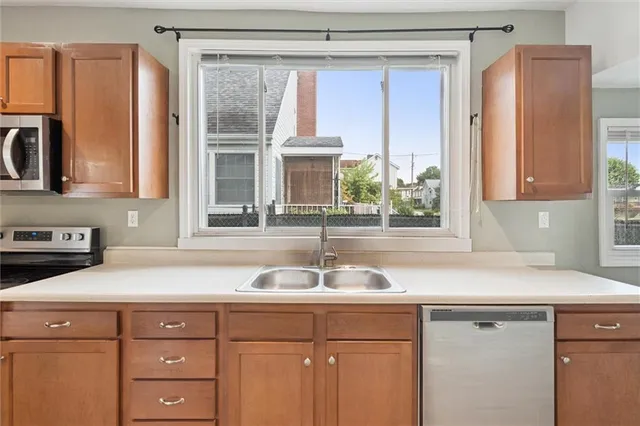 a kitchen with a sink window and cabinets