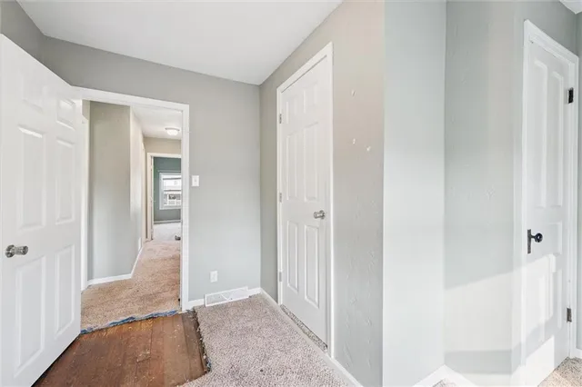 an empty room with a window and a ceiling fan