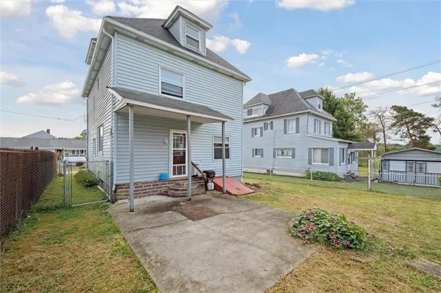 a view of a house with a yard and sitting area