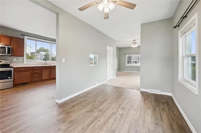 a kitchen with stainless steel appliances granite countertop a stove a sink and a microwave