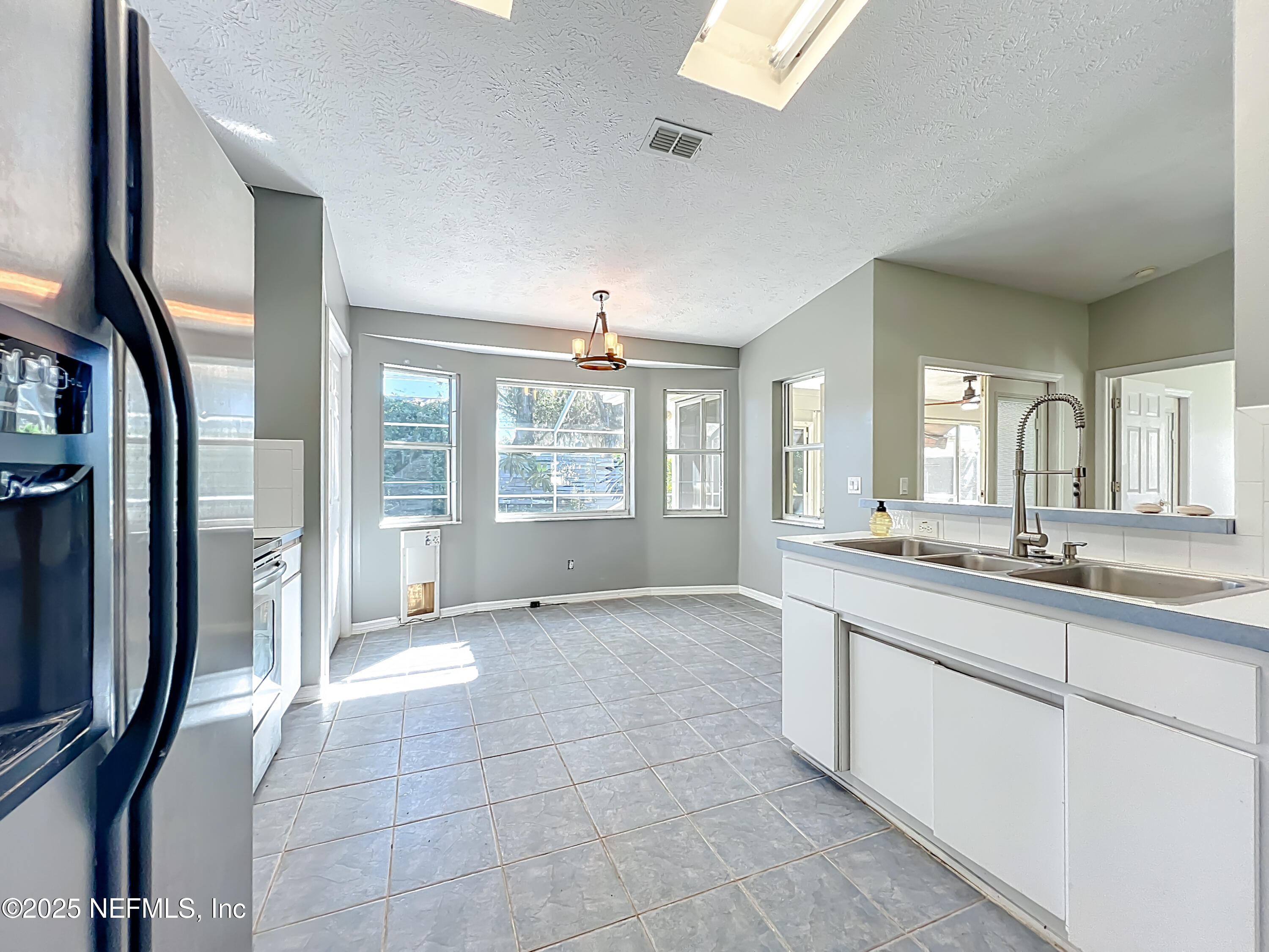 3061 South Franklin Terrace Inverness, FL 34450 - Photo 32 of 65 a large bathroom with a granite countertop sink a large mirror and a bathtub