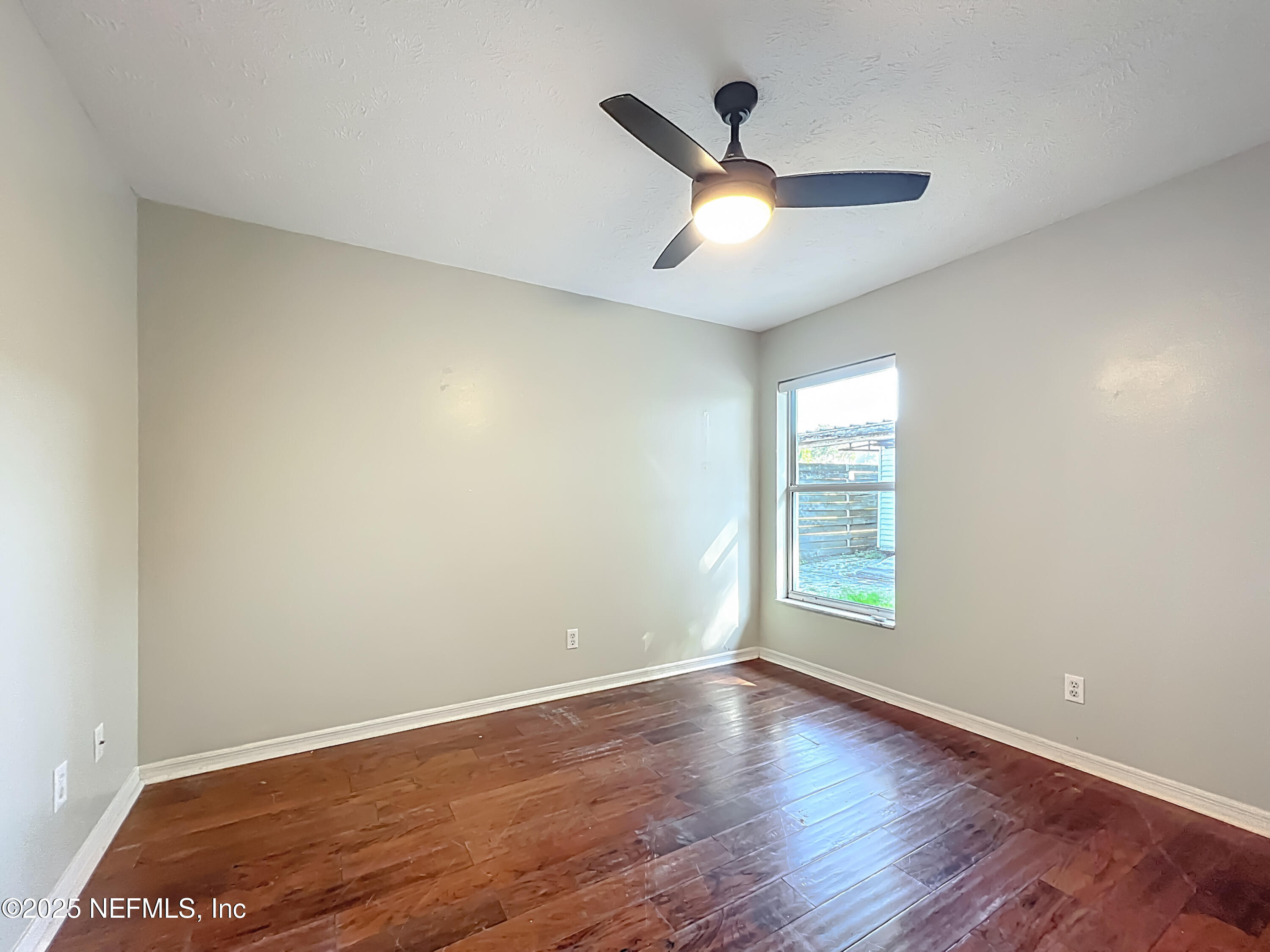 3061 South Franklin Terrace Inverness, FL 34450 - Photo 33 of 65 an empty room with wooden floor fan and windows