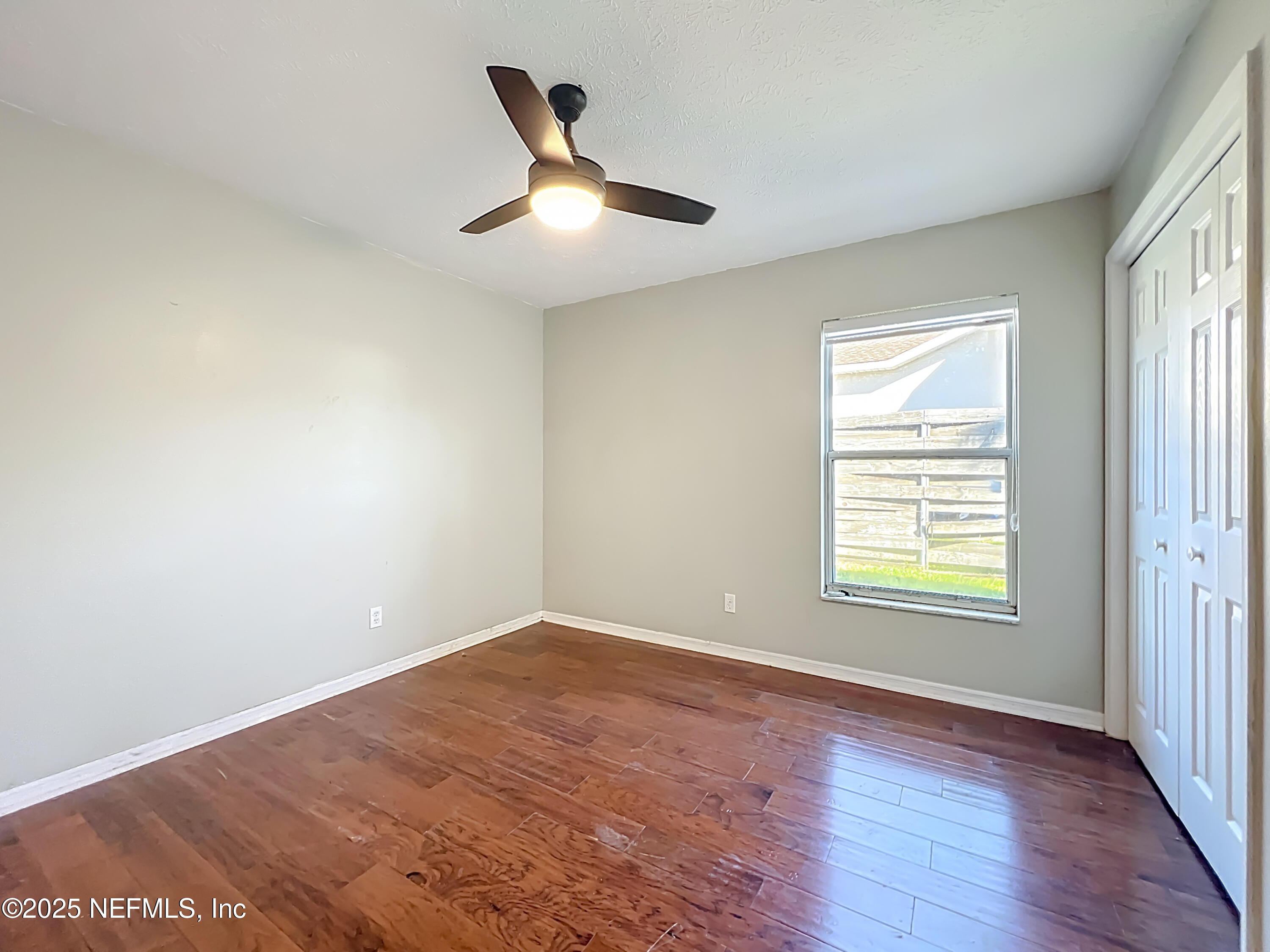 3061 South Franklin Terrace Inverness, FL 34450 - Photo 35 of 65 an empty room with wooden floor fan and windows