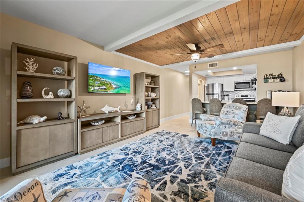 200 Lenell Road, Unit 215 Fort Myers Beach, FL 33931 - Photo 13 of 29 a living room with furniture and a flat screen tv