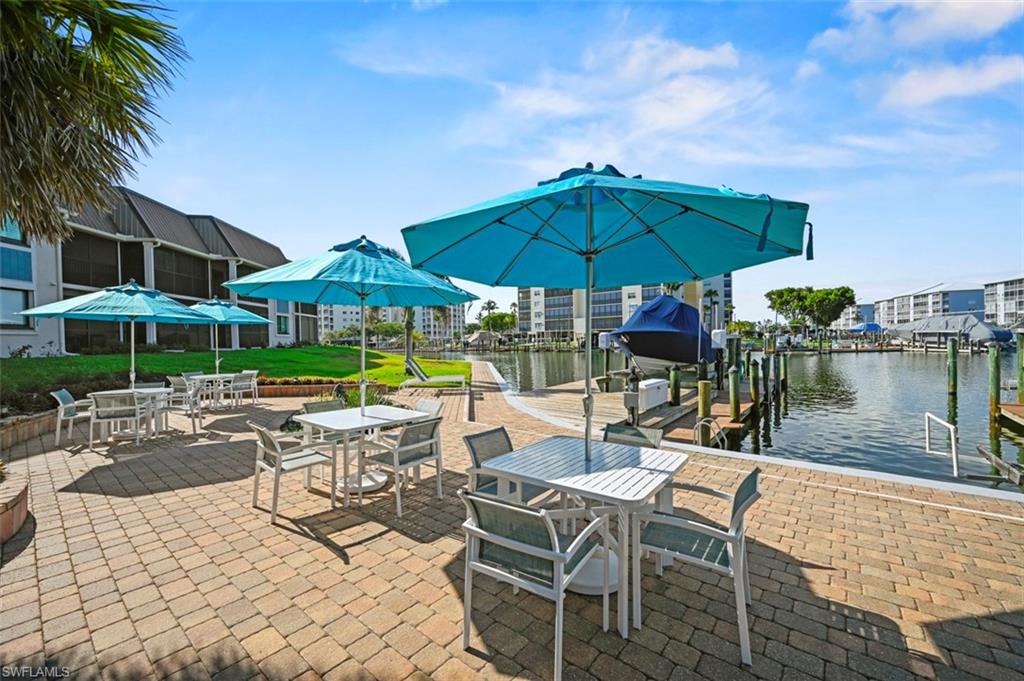 200 Lenell Road, Unit 215 Fort Myers Beach, FL 33931 - Photo 14 of 29 a view of a patio with a table and chairs under an umbrella