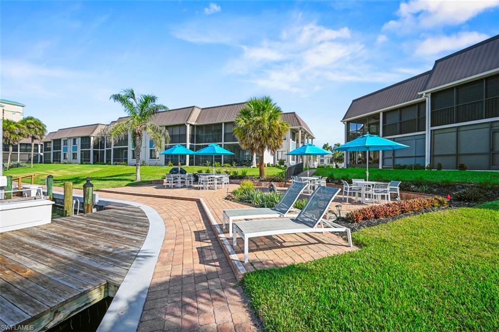 200 Lenell Road, Unit 215 Fort Myers Beach, FL 33931 - Photo 15 of 29 a view of a house with a yard and sitting area