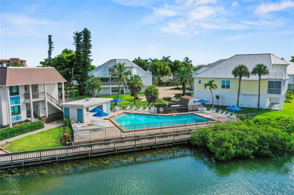 200 Lenell Road, Unit 215 Fort Myers Beach, FL 33931 - Photo 17 of 29 an aerial view of a house with swimming pool a yard and lake view