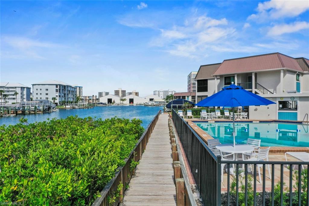 200 Lenell Road, Unit 215 Fort Myers Beach, FL 33931 - Photo 18 of 29 a view of a house with a yard and potted plants