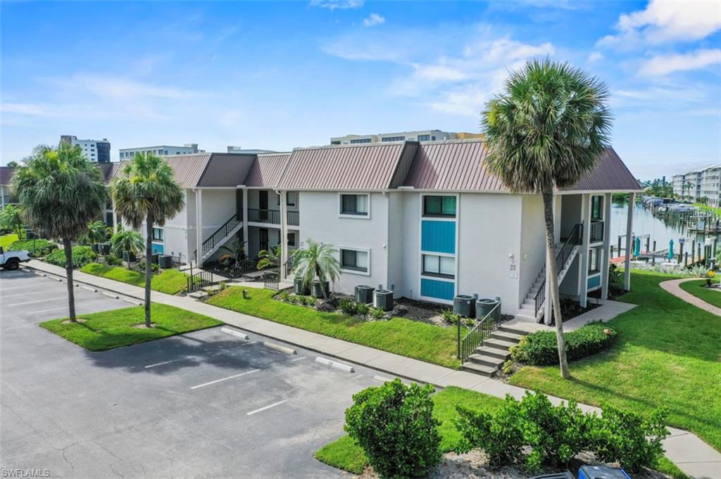200 Lenell Road, Unit 215 Fort Myers Beach, FL 33931 - Photo 20 of 29 a front view of a house with garden