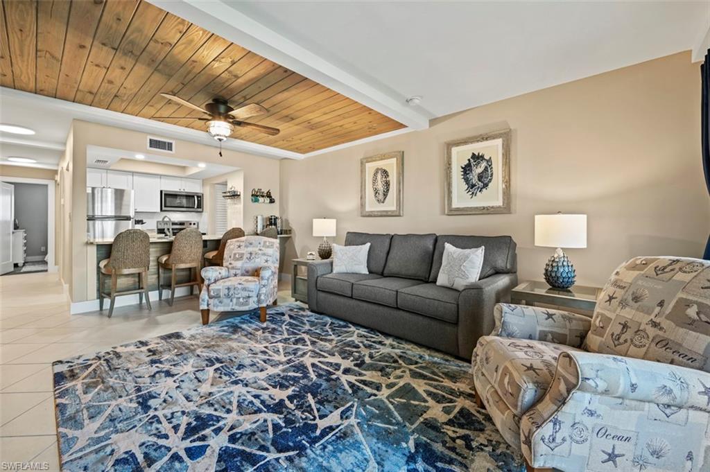 200 Lenell Road, Unit 215 Fort Myers Beach, FL 33931 - Photo 2 of 29 a living room with furniture and wooden floor
