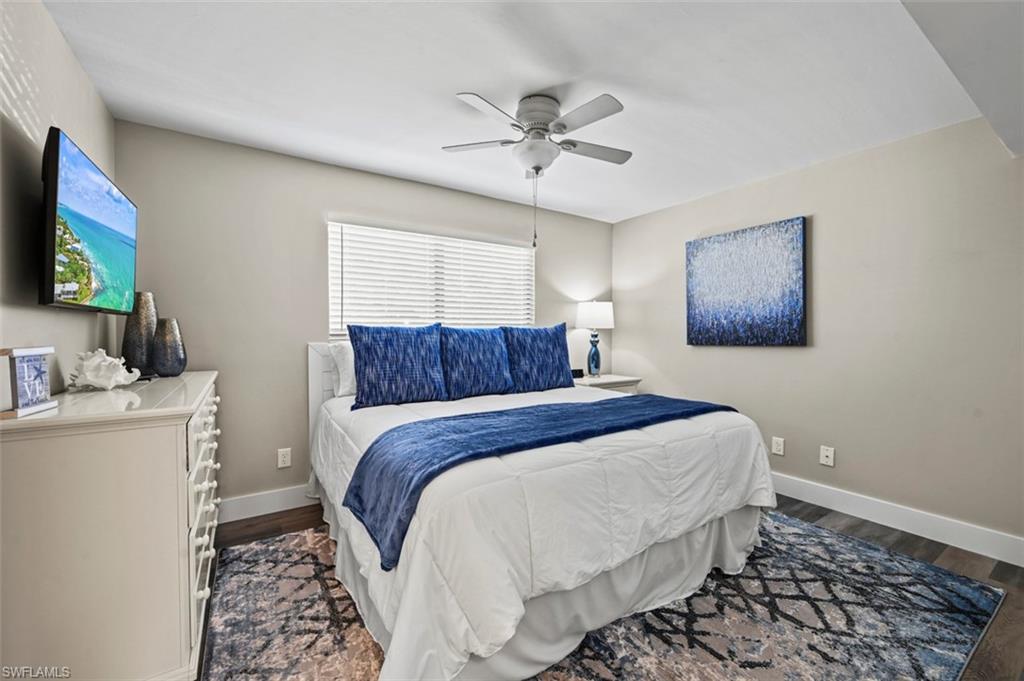 200 Lenell Road, Unit 215 Fort Myers Beach, FL 33931 - Photo 8 of 29 a bedroom with a bed and a flat screen tv