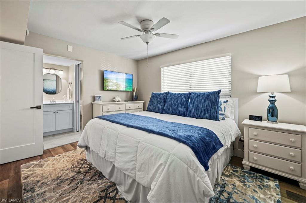 200 Lenell Road, Unit 215 Fort Myers Beach, FL 33931 - Photo 9 of 29 a bedroom with a bed and a flat screen tv