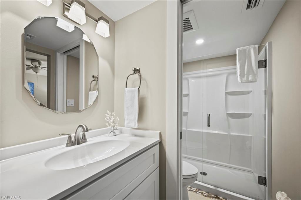 200 Lenell Road, Unit 215 Fort Myers Beach, FL 33931 - Photo 10 of 29 a bathroom with a double vanity sink mirror and shower
